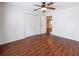 Bedroom with wood floors, standard closet, and view into the entry hall at 507 E Curlew Pl, Tarpon Springs, FL 34689