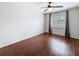 Bright bedroom featuring rich wood floors, ceiling fan, and natural light from a window at 507 E Curlew Pl, Tarpon Springs, FL 34689