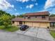 Exterior view of home with a three-car garage and well-maintained landscaping at 507 E Curlew Pl, Tarpon Springs, FL 34689