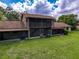 Back of the house featuring a screened-in lanai on the first and second level at 507 E Curlew Pl, Tarpon Springs, FL 34689