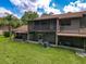 Back of the house featuring a screened-in lanai on the first and second level at 507 E Curlew Pl, Tarpon Springs, FL 34689