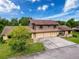 A charming home with a three-car garage and a well-maintained front yard at 507 E Curlew Pl, Tarpon Springs, FL 34689