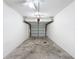 A clean, empty garage with overhead lighting and mechanical door lift at 507 E Curlew Pl, Tarpon Springs, FL 34689