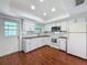 Well-lit kitchen featuring modern appliances, white cabinetry, and a functional layout at 507 E Curlew Pl, Tarpon Springs, FL 34689