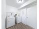 Functional laundry room features white washer and dryer, and vinyl flooring at 507 E Curlew Pl, Tarpon Springs, FL 34689