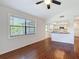 An open-concept living room with wood floors and a seamless flow to the kitchen at 507 E Curlew Pl, Tarpon Springs, FL 34689
