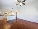 Open concept living room with wood floors and adjacent kitchen at 507 E Curlew Pl, Tarpon Springs, FL 34689
