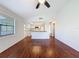 Open concept living room with wood floors and adjacent kitchen at 507 E Curlew Pl, Tarpon Springs, FL 34689