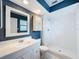 Well-lit bathroom featuring white tile, a vanity with ample storage, and a walk-in shower at 507 E Curlew Pl, Tarpon Springs, FL 34689