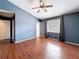 A spacious main bedroom featuring beautiful floors, a ceiling fan, and lots of natural light at 507 E Curlew Pl, Tarpon Springs, FL 34689