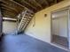 Back patio with wooden stairs and a door leading into the home at 507 E Curlew Pl, Tarpon Springs, FL 34689