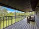 Screened in patio with wood flooring and views of the lawn at 507 E Curlew Pl, Tarpon Springs, FL 34689