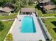 Aerial view of a fenced in community pool and pool house at 507 E Curlew Pl, Tarpon Springs, FL 34689