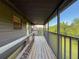 Enjoy the view from this screened porch with wood floors and metal railing at 507 E Curlew Pl, Tarpon Springs, FL 34689