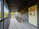 Long screened porch with wood decking and metal railing at 507 E Curlew Pl, Tarpon Springs, FL 34689