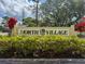 Community signage for North Village with colorful landscaping features at 507 E Curlew Pl, Tarpon Springs, FL 34689