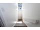 Carpeted staircase with wood trim and high ceilings with windows for natural light at 507 E Curlew Pl, Tarpon Springs, FL 34689