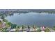 Aerial view of lakefront homes showcases serene water and lush landscape in a vibrant community at 5109 Vinson Dr, Tampa, FL 33610