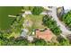 Aerial view showcases community amenities, including a lake pier and playground, near homes and trees at 5109 Vinson Dr, Tampa, FL 33610
