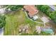 Aerial view of a property with a volleyball net, playground, basketball court, and outbuildings at 5109 Vinson Dr, Tampa, FL 33610