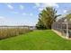 Lush backyard with dock and screened in pool, overlooking the lake at 5109 Vinson Dr, Tampa, FL 33610