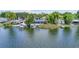 Waterfront backyard featuring multiple docks, boat lifts, and direct access to the serene lake at 5109 Vinson Dr, Tampa, FL 33610