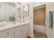 Bright bathroom featuring a single vanity, tub and shower combination, and ample lighting at 5109 Vinson Dr, Tampa, FL 33610