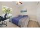 Bright bedroom with a large window, ceiling fan, and a closet, offering a cozy and functional space at 5109 Vinson Dr, Tampa, FL 33610