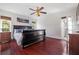 Bedroom featuring hardwood floors, a large bed, and windows providing natural light at 5109 Vinson Dr, Tampa, FL 33610