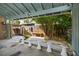 This shows a view of the carport with seating and landscaping at 5109 Vinson Dr, Tampa, FL 33610