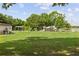 Community park features a playground, volleyball net, covered picnic area, and access to a lake on a sunny day at 5109 Vinson Dr, Tampa, FL 33610