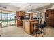 Open kitchen with wooden cabinets, stainless steel appliances, island, and pool view at 5109 Vinson Dr, Tampa, FL 33610