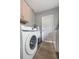 Functional laundry room with a washer, dryer, water heater and ample storage space, offering convenience at 5109 Vinson Dr, Tampa, FL 33610