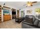 Bright living room features built-in shelves, an entertainment center, and comfortable leather sofa at 5109 Vinson Dr, Tampa, FL 33610
