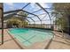Large screened-in pool features ample deck space and lake views at 5109 Vinson Dr, Tampa, FL 33610