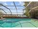The screened-in pool has lake views with plenty of room for swimming and relaxing at 5109 Vinson Dr, Tampa, FL 33610