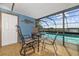 Charming screened-in pool area with outdoor seating and beautiful waterfront views, perfect for relaxation at 5109 Vinson Dr, Tampa, FL 33610