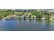 Waterfront homes line a scenic lake, enhanced by lush foliage and calming water views at 5109 Vinson Dr, Tampa, FL 33610