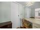 Bathroom vanity with mirror and chair, next to a white door at 5157 Silent Loop # 208, New Port Richey, FL 34652
