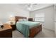 Well-lit bedroom showcasing a wooden bed frame and a tranquil, uncluttered aesthetic at 5157 Silent Loop # 208, New Port Richey, FL 34652