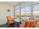 Relaxing Florida room with comfortable seating and a view of the neighborhood swimming pool at 5157 Silent Loop # 208, New Port Richey, FL 34652
