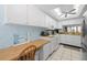 Bright kitchen featuring white cabinets, a ceiling fan, and natural light offering a functional cooking and dining space at 5157 Silent Loop # 208, New Port Richey, FL 34652