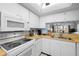 Classic kitchen featuring white appliances, wooden countertops, and well-organized cooking space for everyday meals at 5157 Silent Loop # 208, New Port Richey, FL 34652
