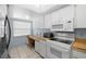 Functional kitchen design with a desk, white appliances, and ample cabinet space at 5157 Silent Loop # 208, New Port Richey, FL 34652