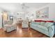 Open-concept living area with hardwood floors and access to the dining area and kitchen at 5157 Silent Loop # 208, New Port Richey, FL 34652