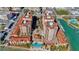 Overhead view of luxurious condominiums featuring a pool, waterfront access, and lush landscaping at 521 Mandalay Ave # 307, Clearwater Beach, FL 33767