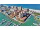 Aerial view of waterfront condos with a marina, oceanfront, and nearby businesses and hotels at 521 Mandalay Ave # 307, Clearwater Beach, FL 33767