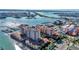 Picturesque aerial shot featuring waterfront condos, a marina, and the bridge to nearby mainland at 521 Mandalay Ave # 307, Clearwater Beach, FL 33767