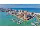 Panoramic aerial of beachfront condos, a marina filled with boats, and crystal-clear ocean water at 521 Mandalay Ave # 307, Clearwater Beach, FL 33767