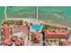 Bird's eye view featuring a pool, red tile roofs, and well-maintained landscaping along the waterfront at 521 Mandalay Ave # 307, Clearwater Beach, FL 33767